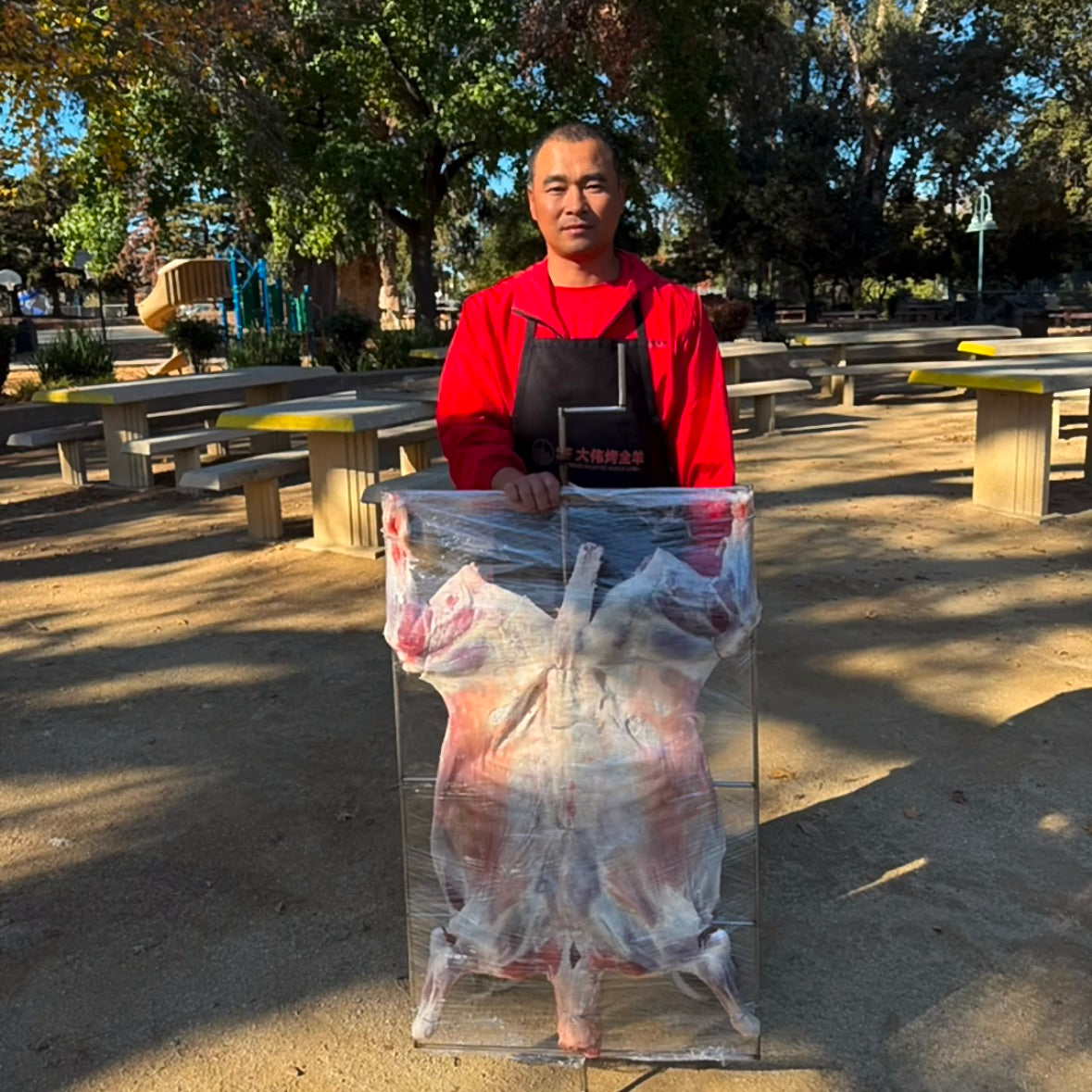 Whole lamb ready for on-site roast catering at a Bay Area private event
